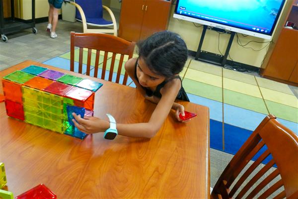 student with colorful blocks